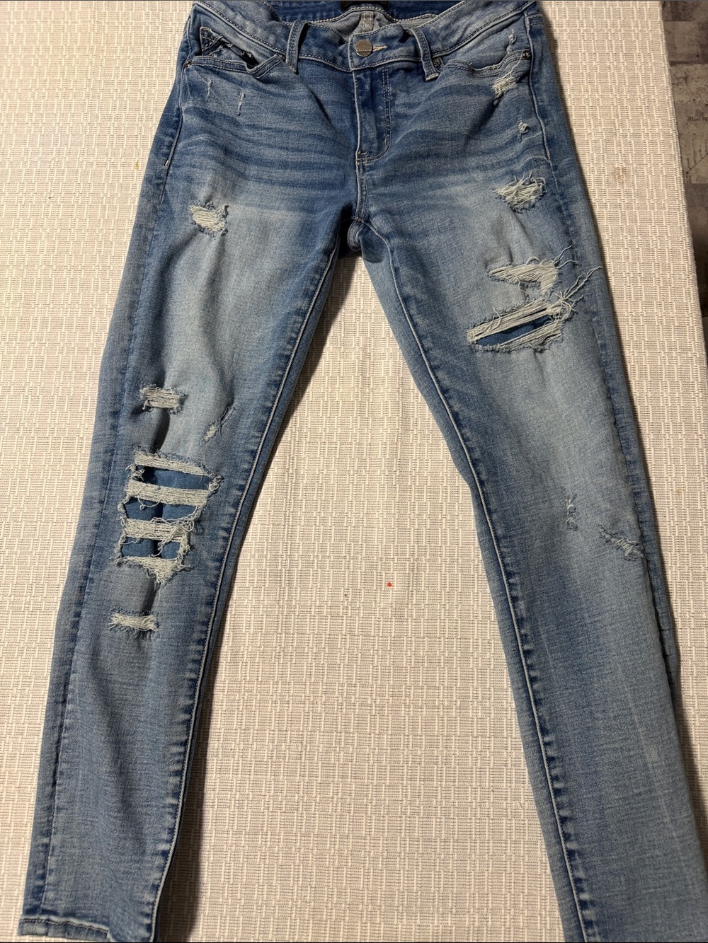 Buckle Light Wash Distressed Skinny Jeans